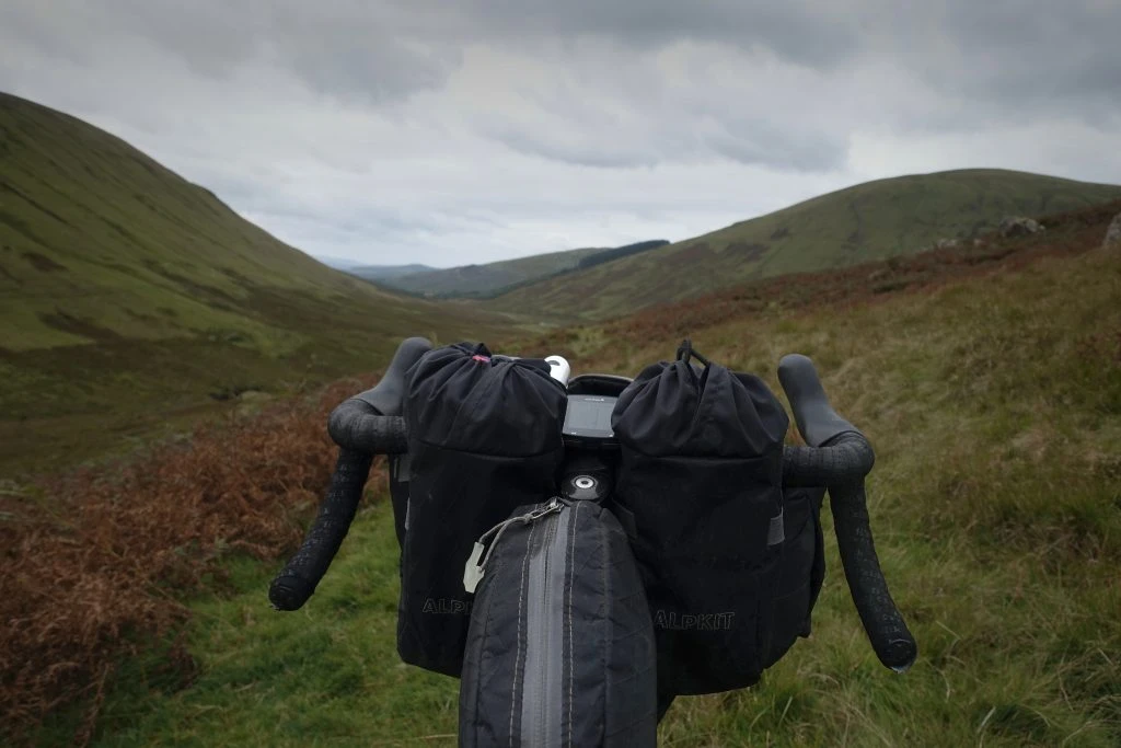Viewing the hills beyond the loaded cockpit of the bike